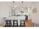 Modern kitchen featuring a stainless steel refrigerator and bar seating with pendant lights at 1238 N Tennyson St, Denver, CO 80204