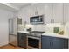 Close up of a modern kitchen with stainless steel appliances and gray cabinets at 1238 N Tennyson St, Denver, CO 80204