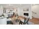 Stylish living room with hardwood floors and fireplace adjacent to an open kitchen with barstool seating at 1238 N Tennyson St, Denver, CO 80204