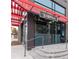 Exterior view of Sloan's Lake Tap & Burger featuring a modern design with a red awning and inviting entrance at 1238 N Tennyson St, Denver, CO 80204