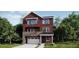 A charming two-story home with a brick and siding facade, plus a white garage door at 8847 Waterleaf Ln, Littleton, CO 80125