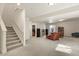 Spacious basement with carpet, stairway, and a seating area with a brown leather chair at 4478 Riviera Ct, Aurora, CO 80019