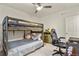 Bedroom featuring a wooden bunk bed, desk, ceiling fan, and built in storage at 4478 Riviera Ct, Aurora, CO 80019