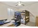bedroom with wooden bunk beds, ceiling fan, gray carpet, and a computer desk at 4478 Riviera Ct, Aurora, CO 80019