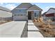 Charming home with a two-car garage, stone accents, and a well-maintained front yard at 4478 Riviera Ct, Aurora, CO 80019