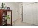 Hallway featuring closet with bi-fold doors and an open doorway leading to another room at 4478 Riviera Ct, Aurora, CO 80019
