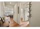 Inviting entryway with wood floors, leading to an open-concept living area and bathroom at 4478 Riviera Ct, Aurora, CO 80019