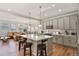 Modern kitchen with a large island, pendant lighting, and stainless steel appliances at 4478 Riviera Ct, Aurora, CO 80019