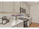 Kitchen features modern appliances, stone backsplash, and lots of counter space at 4478 Riviera Ct, Aurora, CO 80019