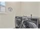 Modern laundry room with LG washer and dryer, laundry room sign, and natural light at 4478 Riviera Ct, Aurora, CO 80019