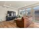 Living room with a large television, brown couch, and plenty of natural light at 4478 Riviera Ct, Aurora, CO 80019