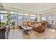 Bright living room featuring a comfortable brown sectional couch and large windows at 4478 Riviera Ct, Aurora, CO 80019