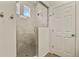 Tiled shower with glass door and modern showerhead at 4478 Riviera Ct, Aurora, CO 80019