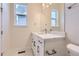 Bathroom features white cabinets, quartz countertops, modern fixtures, and a well-lit mirror at 11453 Autumn Moon St, Littleton, CO 80125