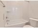 Bright bathroom with a tub and shower combo with tiled walls, and modern fixtures at 11453 Autumn Moon St, Littleton, CO 80125