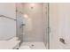 Bathroom features a glass-enclosed shower with tiled walls, modern fixtures, and a sleek design at 11453 Autumn Moon St, Littleton, CO 80125