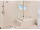 A luxurious bathroom features a glass-enclosed shower with a separate soaking tub for relaxation and convenience at 11453 Autumn Moon St, Littleton, CO 80125