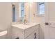 Bright bathroom featuring modern fixtures, white cabinetry, quartz countertop, and a stylish faucet at 11453 Autumn Moon St, Littleton, CO 80125