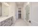 A bright bathroom boasts a marble vanity and a glass shower offering both style and functionality at 11453 Autumn Moon St, Littleton, CO 80125