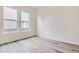 Bedroom featuring light wood flooring, two windows, and neutral walls at 11453 Autumn Moon St, Littleton, CO 80125