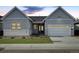 Charming home with a two-car garage, well-maintained lawn and attractive stone accents at 11453 Autumn Moon St, Littleton, CO 80125