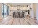 Modern kitchen featuring white cabinets, an island with bar seating, and stainless steel appliances at 11453 Autumn Moon St, Littleton, CO 80125