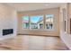 Bright living room featuring modern fireplace, hardwood floors, and large windows at 11453 Autumn Moon St, Littleton, CO 80125