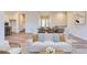 Living area showcases a modern white sofa and flows into the dining area with wood flooring at 11453 Autumn Moon St, Littleton, CO 80125