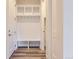 A mudroom with a convenient bench, hooks, and upper shelving for optimal organization when entering or leaving the home at 11453 Autumn Moon St, Littleton, CO 80125