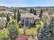 Expansive backyard featuring a multi-tiered deck and lush landscaping, perfect for outdoor living at 3266 Coyote Hills Way, Castle Rock, CO 80109