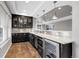 Modern bar area includes custom cabinetry, granite countertops, wine cooler, and modern pendant lighting at 3266 Coyote Hills Way, Castle Rock, CO 80109