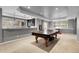 Spacious basement features recessed lighting, a game table, and a bar area, ideal for entertaining and relaxing at 3266 Coyote Hills Way, Castle Rock, CO 80109