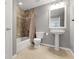 Full bathroom features a pedestal sink, a bathtub with tile surround, and neutral color palette at 3266 Coyote Hills Way, Castle Rock, CO 80109