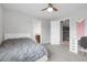 Bright bedroom featuring a ceiling fan, attached bathroom, and a built-in desk at 3266 Coyote Hills Way, Castle Rock, CO 80109