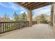 Expansive deck with stone pillar supports overlooks the lush backyard at 3266 Coyote Hills Way, Castle Rock, CO 80109