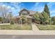 Charming two-story home with a well-maintained lawn and mature trees, creating a welcoming curb appeal at 3266 Coyote Hills Way, Castle Rock, CO 80109