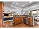 Modern kitchen with an open layout, granite countertops, and seamless flow to the living area, creating a perfect space at 3266 Coyote Hills Way, Castle Rock, CO 80109