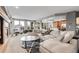 Inviting living room with a cozy fireplace and expansive windows, perfect for relaxation at 3266 Coyote Hills Way, Castle Rock, CO 80109
