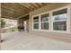Covered patio with a stone pillar, wood beams, and an outdoor grill for entertaining at 3266 Coyote Hills Way, Castle Rock, CO 80109