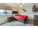 Comfortable bedroom with a full-size bed, ceiling fan and large window at 7700 W Glasgow Pl # 6C, Littleton, CO 80128