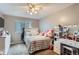 Bright bedroom featuring a full-size bed and vanity/desk area at 7700 W Glasgow Pl # 6C, Littleton, CO 80128