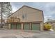 Neutral two-story condo featuring individual garages and an upper-level wooden balcony at 7700 W Glasgow Pl # 6C, Littleton, CO 80128