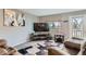 Comfortable living room with a large window, TV, and plush seating at 7700 W Glasgow Pl # 6C, Littleton, CO 80128