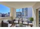 Relax on this balcony featuring wicker furniture and city views; a perfect spot for entertaining at 300 W 11Th Ave # 8C, Denver, CO 80204