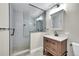 Modern bathroom features a tiled shower with glass partition and a wooden vanity with drawers and a sink at 300 W 11Th Ave # 8C, Denver, CO 80204