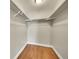 A spacious walk-in closet features hardwood floors, fresh white paint and ample storage with bars at 300 W 11Th Ave # 8C, Denver, CO 80204