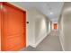 Hallway with neutral walls, carpet, and bright orange doors to the residential units at 300 W 11Th Ave # 8C, Denver, CO 80204