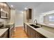 Well-equipped kitchen featuring stainless steel appliances, dark cabinets, and stone countertops at 300 W 11Th Ave # 8C, Denver, CO 80204