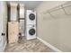 Functional laundry room with stacked washer and dryer, plus convenient metal shelving for storage solutions at 300 W 11Th Ave # 8C, Denver, CO 80204