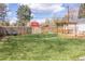 Spacious backyard with a deck, pergola, a cozy seating area, a large grassy lawn and wooden privacy fence at 4825 S Delaware St, Englewood, CO 80110